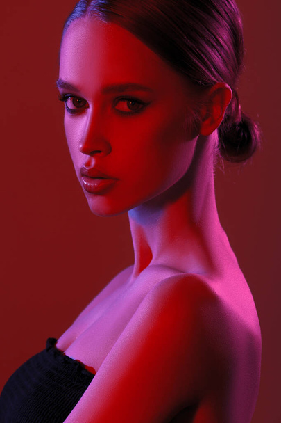 Fashion colorful beauty makeup portrait. Beautiful model girl. Neon lights studio woman closeup portrait - Photo, Image