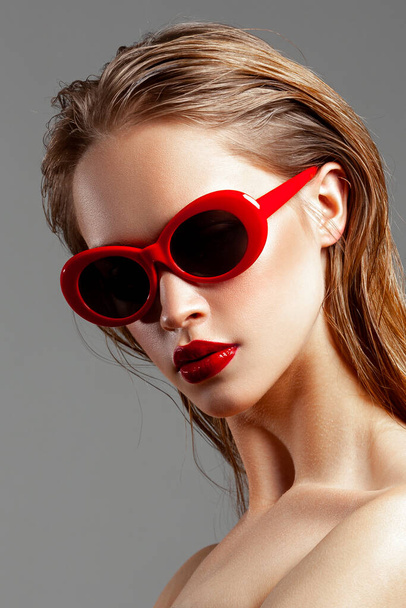 Beautiful young girl with red sunglasses. Fashion beauty portrait. Perfect skin - Zdjęcie, obraz