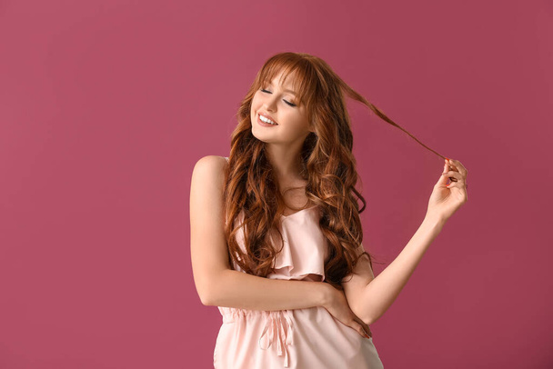 Beautiful young redhead woman on color background - Photo, Image
