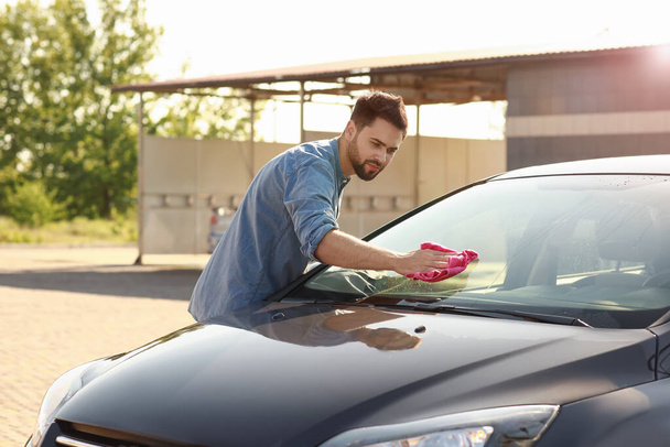 Uomo che lava la sua auto all'aperto - Foto, immagini