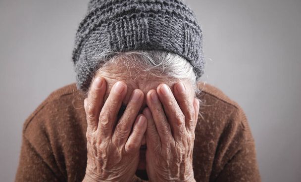 Sad elderly woman covering her face. - Photo, Image