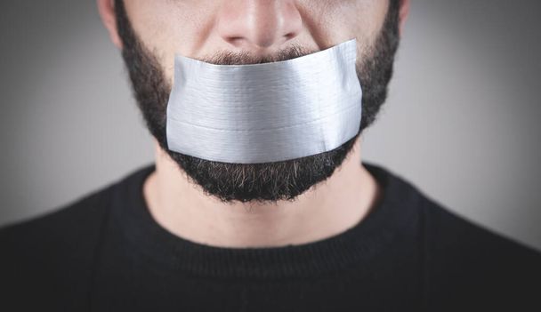 Caucasian man with tape on mouth. Censorship - Photo, Image