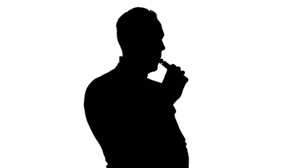 Shooting of coughing mans silhouette with vape - Footage, Video