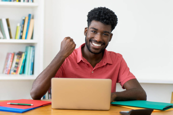 Successful afro american male student learning at computer indoors at home - Photo, image