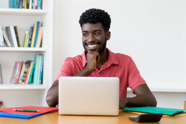 Smart afro american male student at computer indoors at home - Foto, Bild