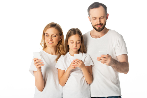 family in white t-shirts using smartphones isolated on white - Фото, зображення
