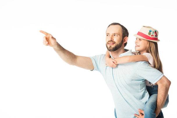 happy father piggybacking daughter and pointing with finger away isolated on white - Foto, afbeelding