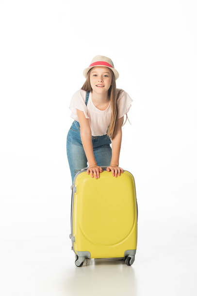 cheerful girl in hat near yellow travel bag isolated on white - Φωτογραφία, εικόνα