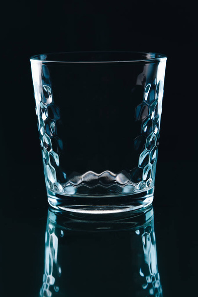 Small shot glass on black background. - Foto, afbeelding