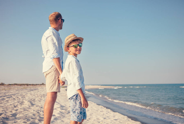 Father with little son stay on the sea beach - Photo, Image