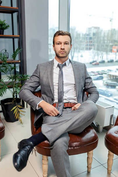 young man in tuxedo sit in his own office - Fotó, kép