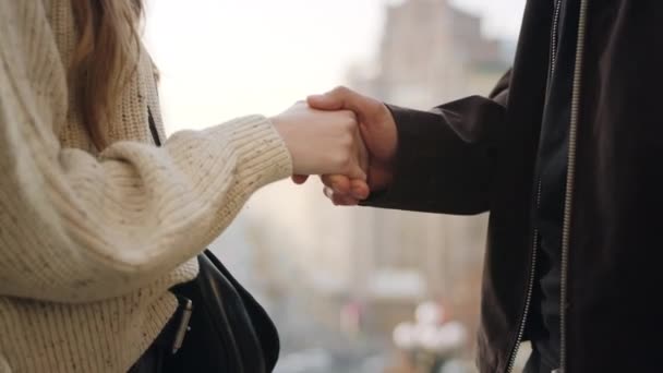 Closeup people hands greeting. Unrecognizable couple shaking hands outdoors. - Filmati, video