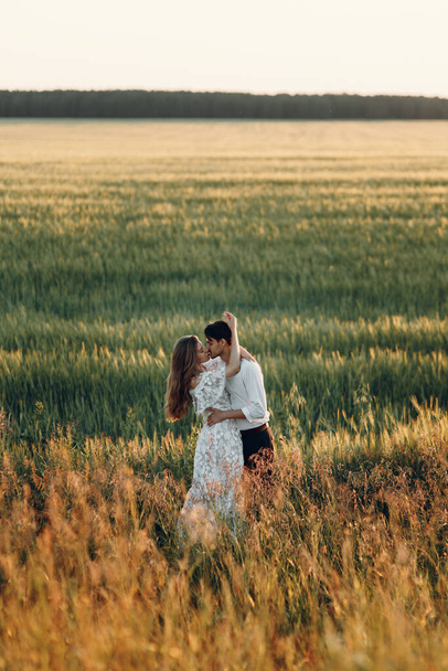 Beautiful couple in nature in boho style. Wedding in European style fine art at sunset. - Foto, Imagen