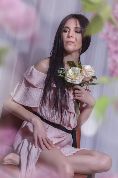 a brunette girl in a light pink dress - Valokuva, kuva