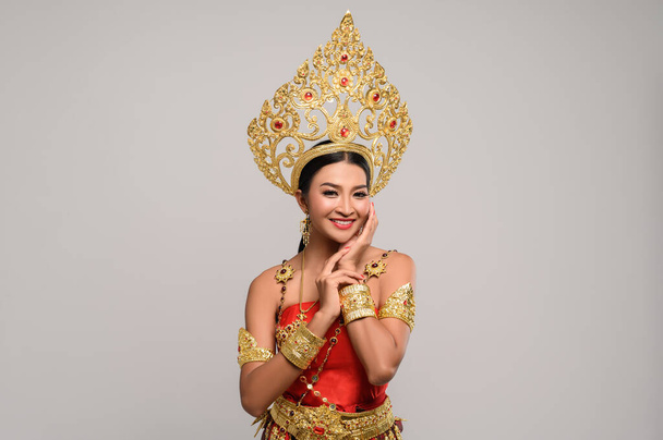 Das Mädchen trägt ein thailändisches Kleid und die Hände berühren das Gesicht. - Foto, Bild
