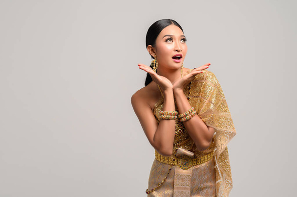 Woman wearing Thai dress as a symbol for wow hands - Foto, afbeelding