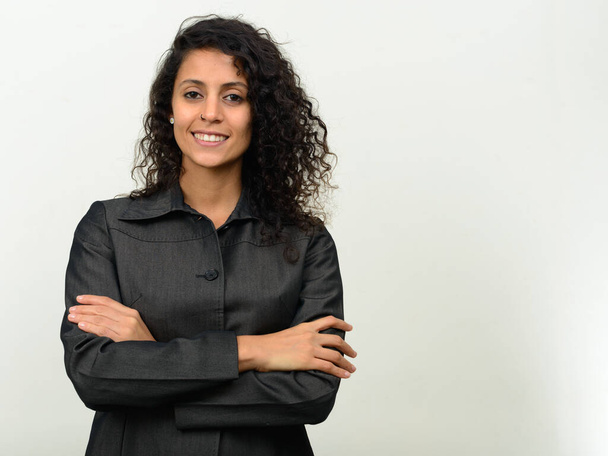 Studio shot of young beautiful Hispanic businesswoman with curly hair   - Фото, зображення