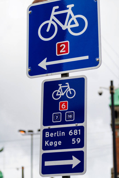Cycling sign in Copenhagen, Denmark with direction to Berlin, Germany - Valokuva, kuva