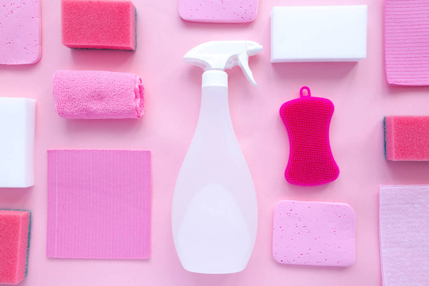 Detergents and cleaning products agent, sponges, napkins and rubber gloves, pink background. Top view - Foto, Bild