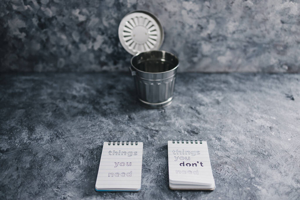 minimalism or self-improvement concept, notepads with texts Things you need and Things you dont need next to each other with trash - Foto, Imagen