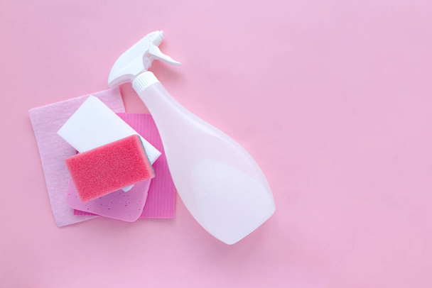 Cleaning products agent, sponges, napkins and rubber gloves, pink background. Top view. Copy space - Foto, afbeelding