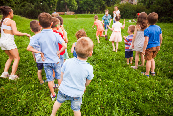 Physical education lesson for children in the summer park - Fotó, kép