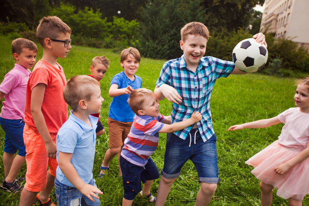 The big boy does not want to share the ball with small children - Foto, Bild