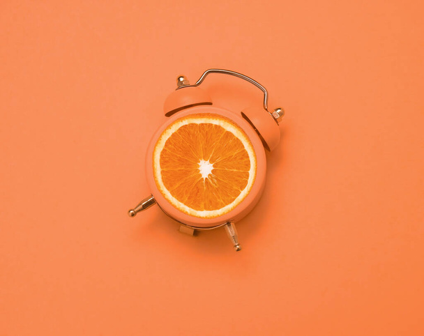 top view flat lay creative art collage alarm clock and orange copy space - Foto, afbeelding