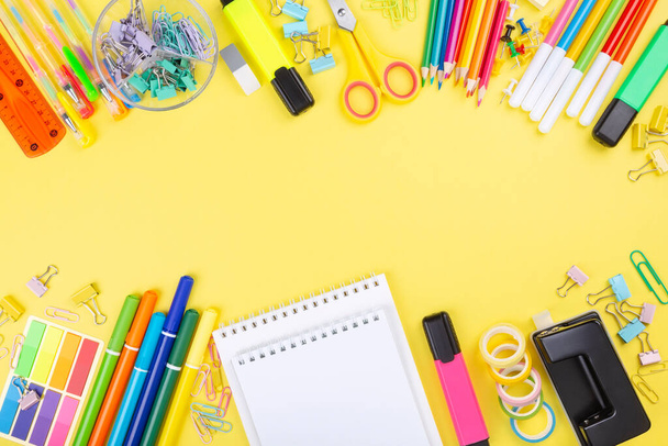 Various school office and painting supplies on yellow background. Back to school concept. Top view. Copy space - Foto, imagen