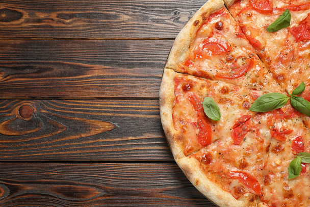 Delicious pizza Margherita on wooden table, top view. Space for text - 写真・画像