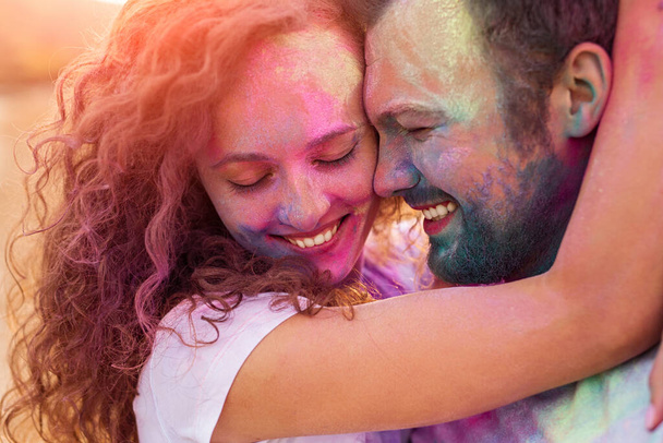 Happy couple hugging during paint party - Photo, Image