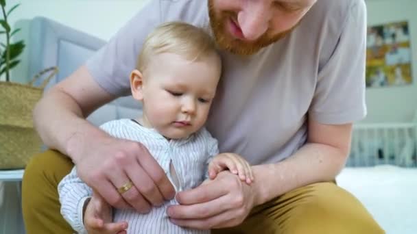 Young father taking care of cute toddler at home - Video