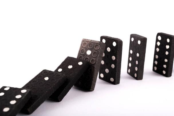 Dominoes in row falling isolated on white background, close up, selective focus - Photo, Image
