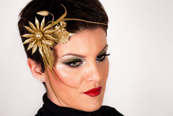 Woman with golden hairpin in short dark hair and make up on face. Close up - Photo, Image