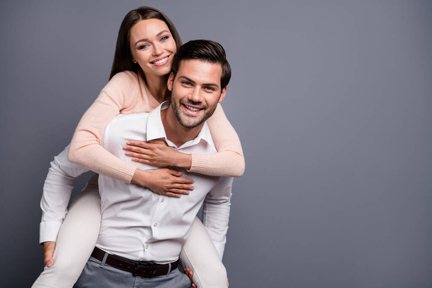 Photo beautiful lady handsome guy couple carry piggyback good mood travelers spend free time happy together quarantine wear shirts pants isolated grey color background - Photo, Image