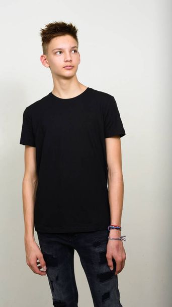 Studio shot of young handsome teenage boy against white background - Photo, Image