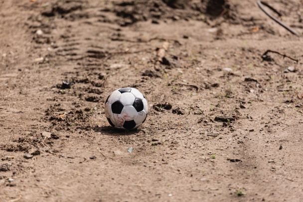Dirty soccer ball on road on urban street  - Foto, imagen