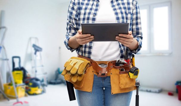 woman or builder with tablet pc and working tools - Fotó, kép