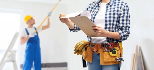 woman with clipboard, pencil and working tools - Foto, afbeelding