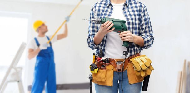 woman or builder with drill and work tools - Fotoğraf, Görsel