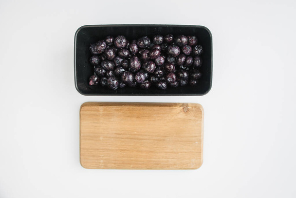 frozen bilberry in a lunch box on white background - Fotografie, Obrázek