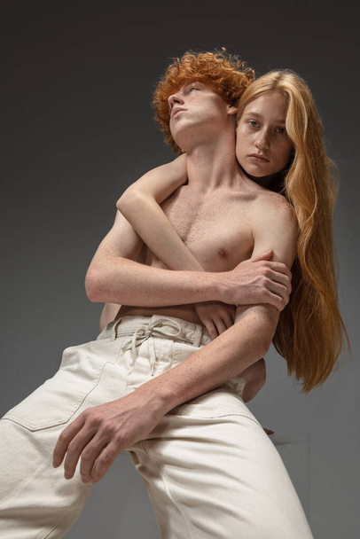Portrait of beautiful redhead couple isolated on grey studio background. Concept of beauty, skin care, fashion and style - Foto, Bild