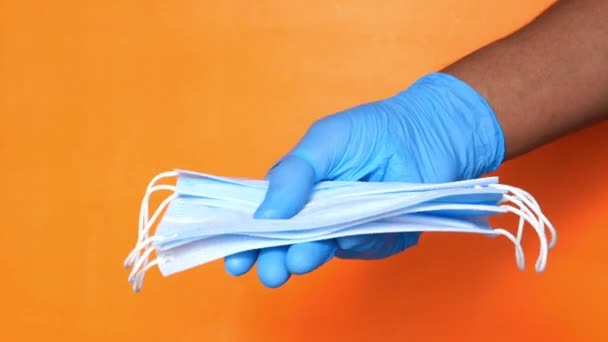 doctor hand in medical glove holding protective surgical face mask, close up  - Footage, Video