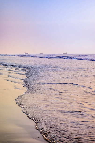 Пляж с силуэтом востока стоил Индии на рассвете ясным утром весеннего времени. - Фото, изображение