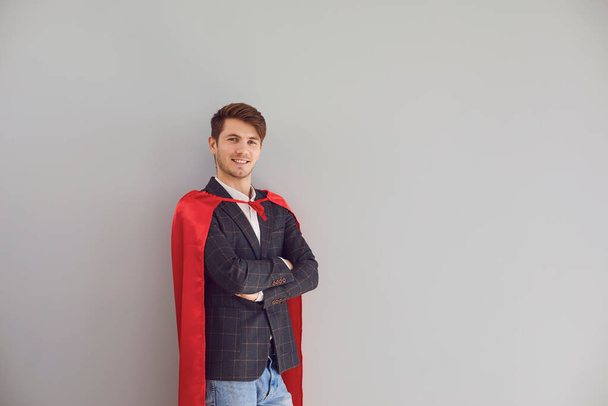 Happy man in superhero costume smile on gray background. - Foto, immagini