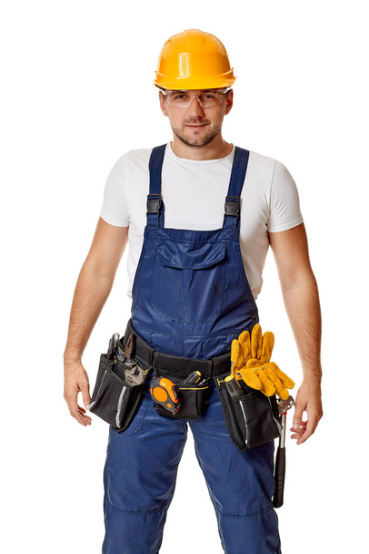 repairman worker in yellow hard hat and uniform. - Foto, imagen
