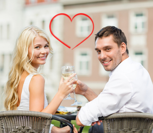 Smiling couple drinking wine in cafe - Zdjęcie, obraz