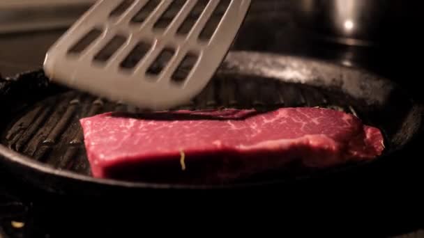 Cook Puts Pieces Of Meat Steaks On The Grill Pan - Materiał filmowy, wideo