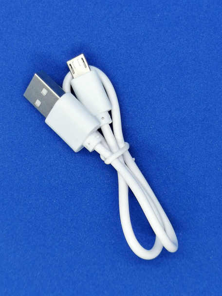 Charging cable type c for a fast phone charge with on a blue propylene background - Photo, Image