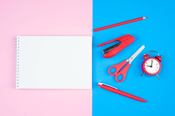 notebook on a pink background with the office on a blue background. High quality photo - Foto, afbeelding